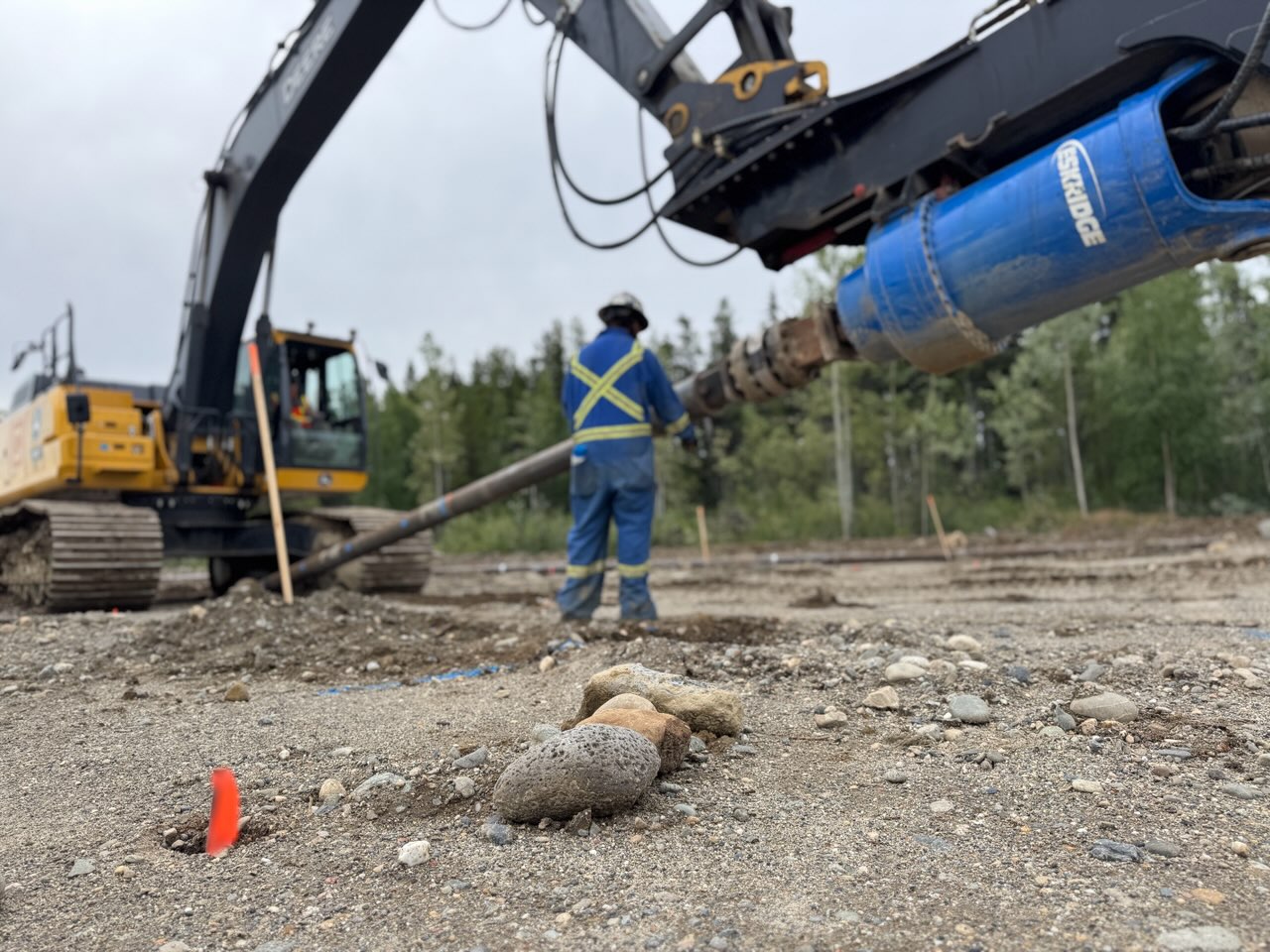 Great Northern Bridgeworks crew monitoring pile driving progress and alignment